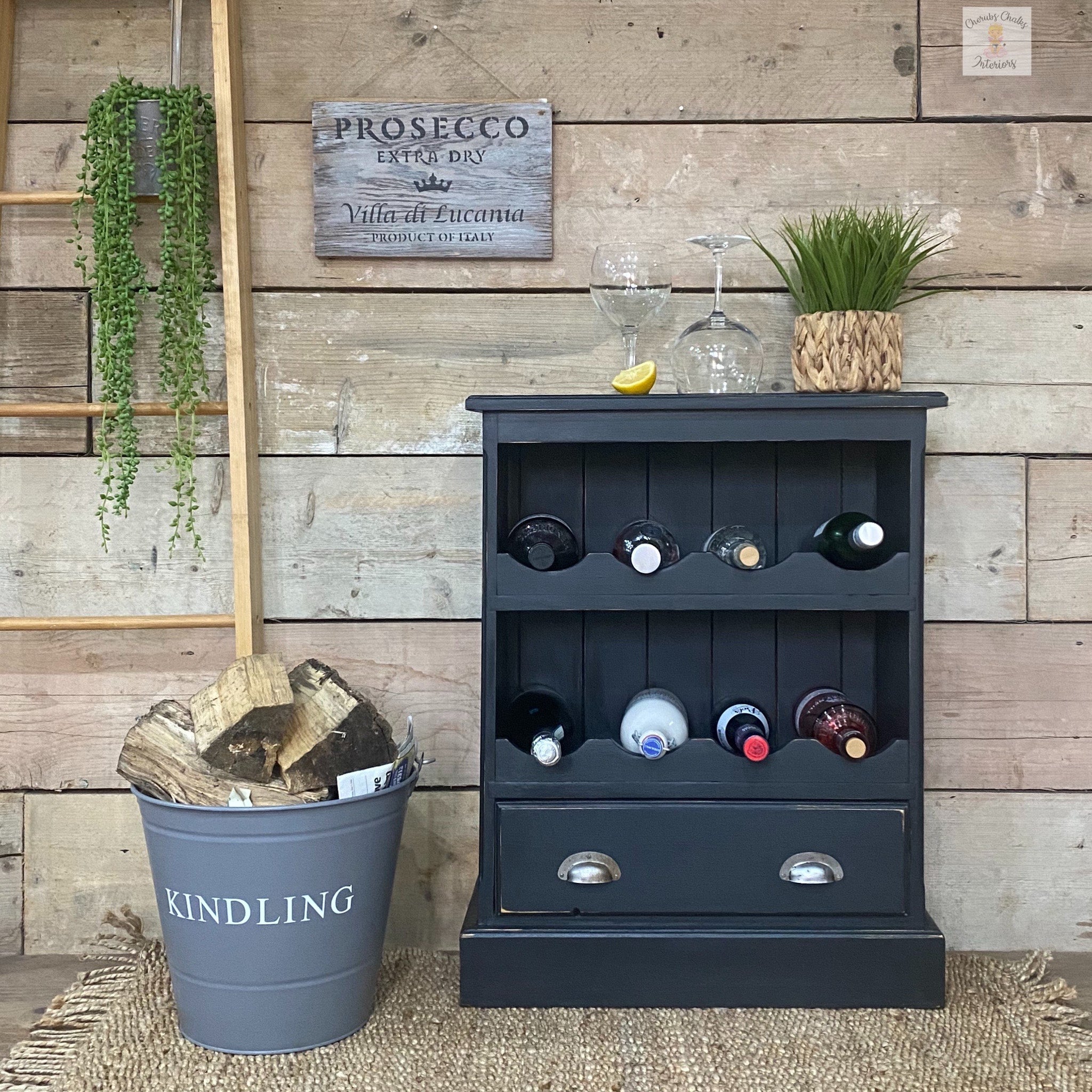 A vintage small wine bottle storage side table refurbished by Cherubs Chalks Interiors is painted in Dixie Belle's Midnight Sky chalk mineral paint.