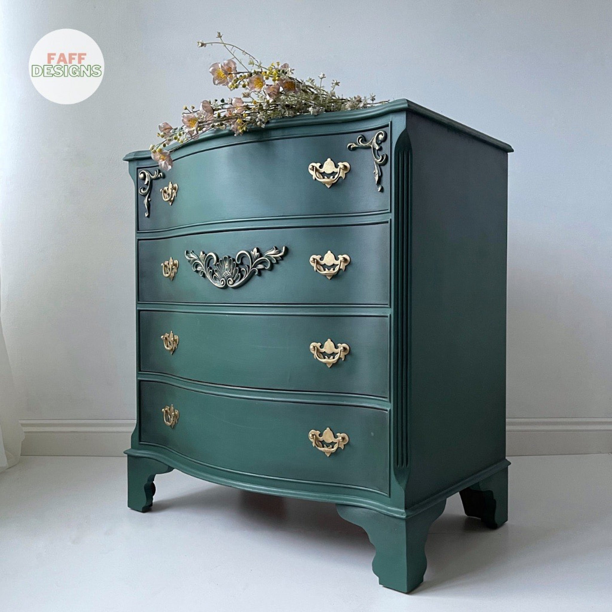 A small 4-drawer dresser refurbished by Faff Designs is painted in Dixie Belle's Palmetto with black wax accenting corners and details.