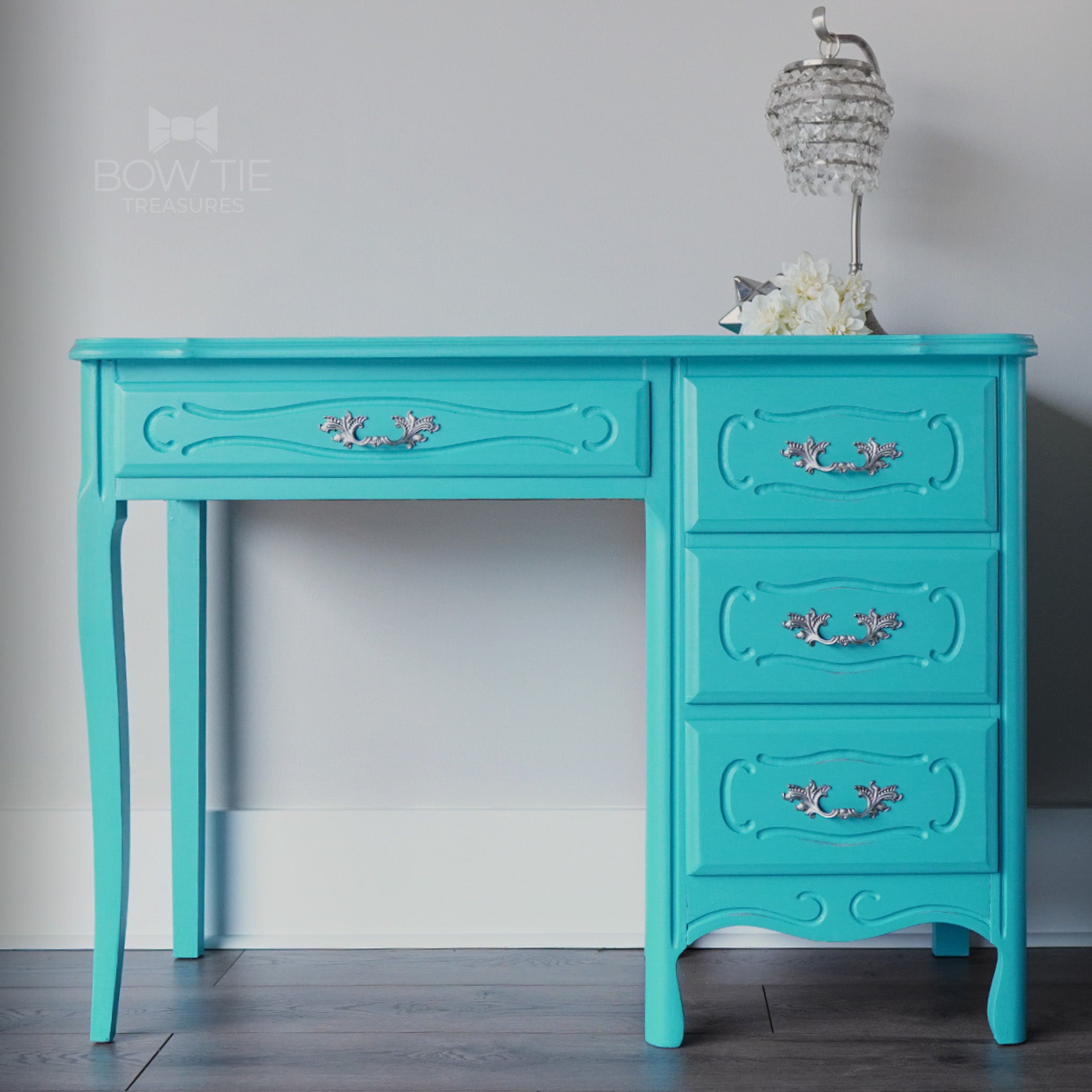 A vintage desk with 4 drawers is painted in Dixie Belle's Pure Ocean chalk mineral paint.