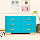 A vintage 6-drawer dresser is painted in Dixie Belle's Pure Ocean chalk mineral paint and has gold accents.