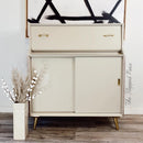 A vintage side table with storage refurbished by The Flipped Piece is painted in Dixie Belle's Sand Bar chalk mineral paint.