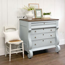 A vintage 4-drawer dresser refurbished by Black Lab Furniture Revival is painted in Dixie Belle's Savannah Mist chalk mineral paint and has a natural wood top.