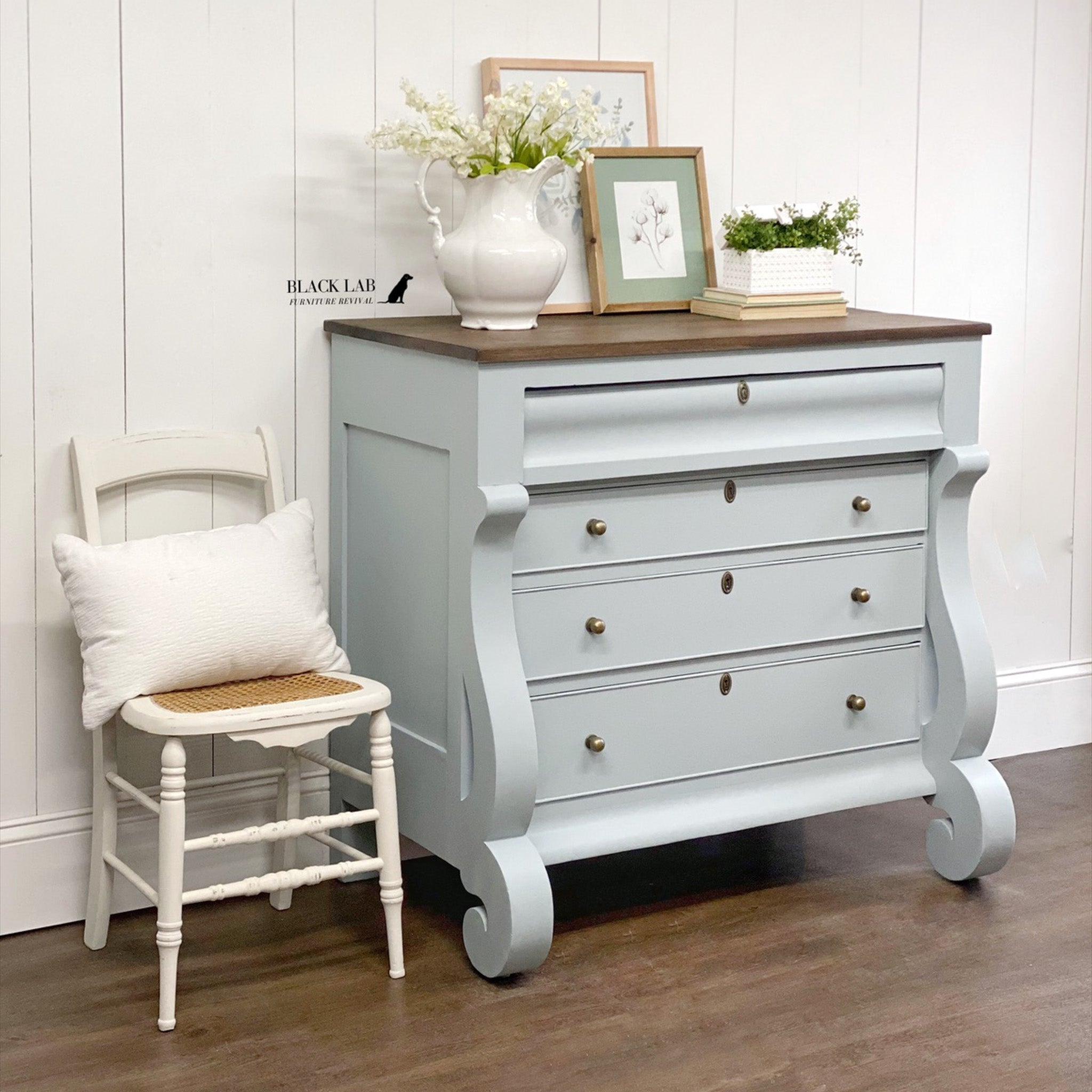 A vintage 4-drawer dresser refurbished by Black Lab Furniture Revival is painted in Dixie Belle's Savannah Mist chalk mineral paint and has a natural wood top.