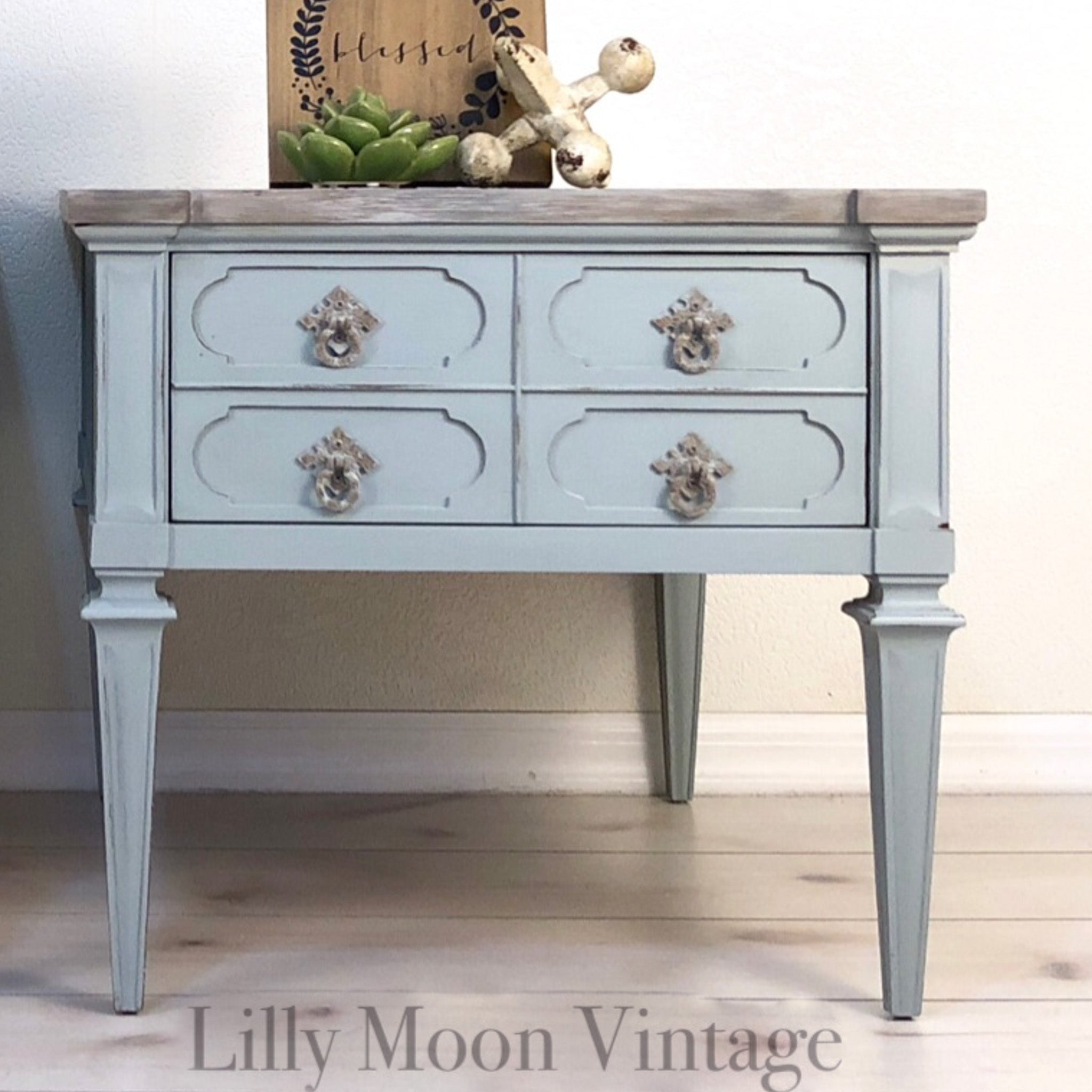 A vintage side table with 4 small drawers refurbished by Lilly Moon Vintage is painted in Dixie Belle's Savannah Mist chalk mineral paint.