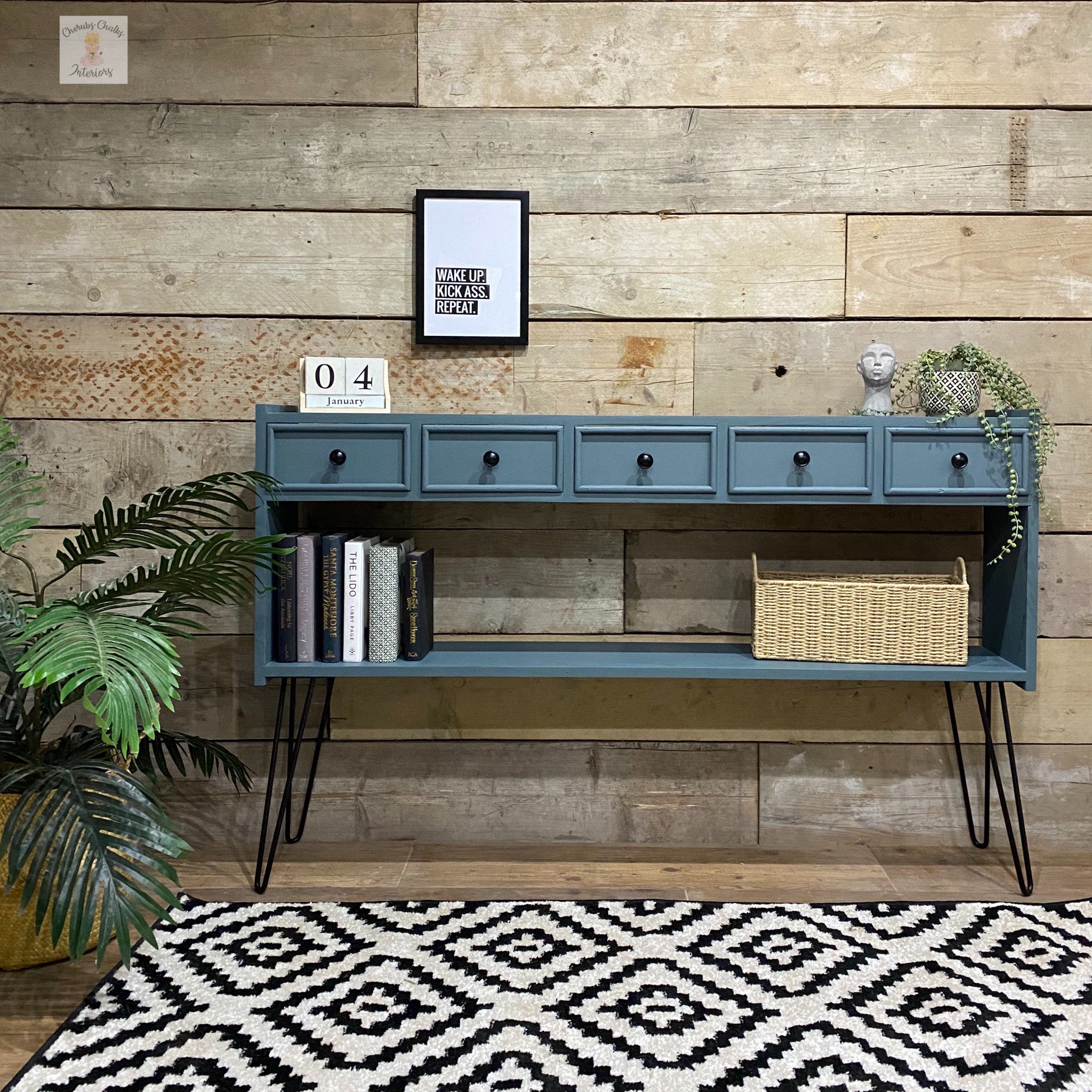 A mid-century console table refurbished by Cherubs Chalks Interiors is painted in Dixie Belle's Stormy Seas chalk mineral paint.
