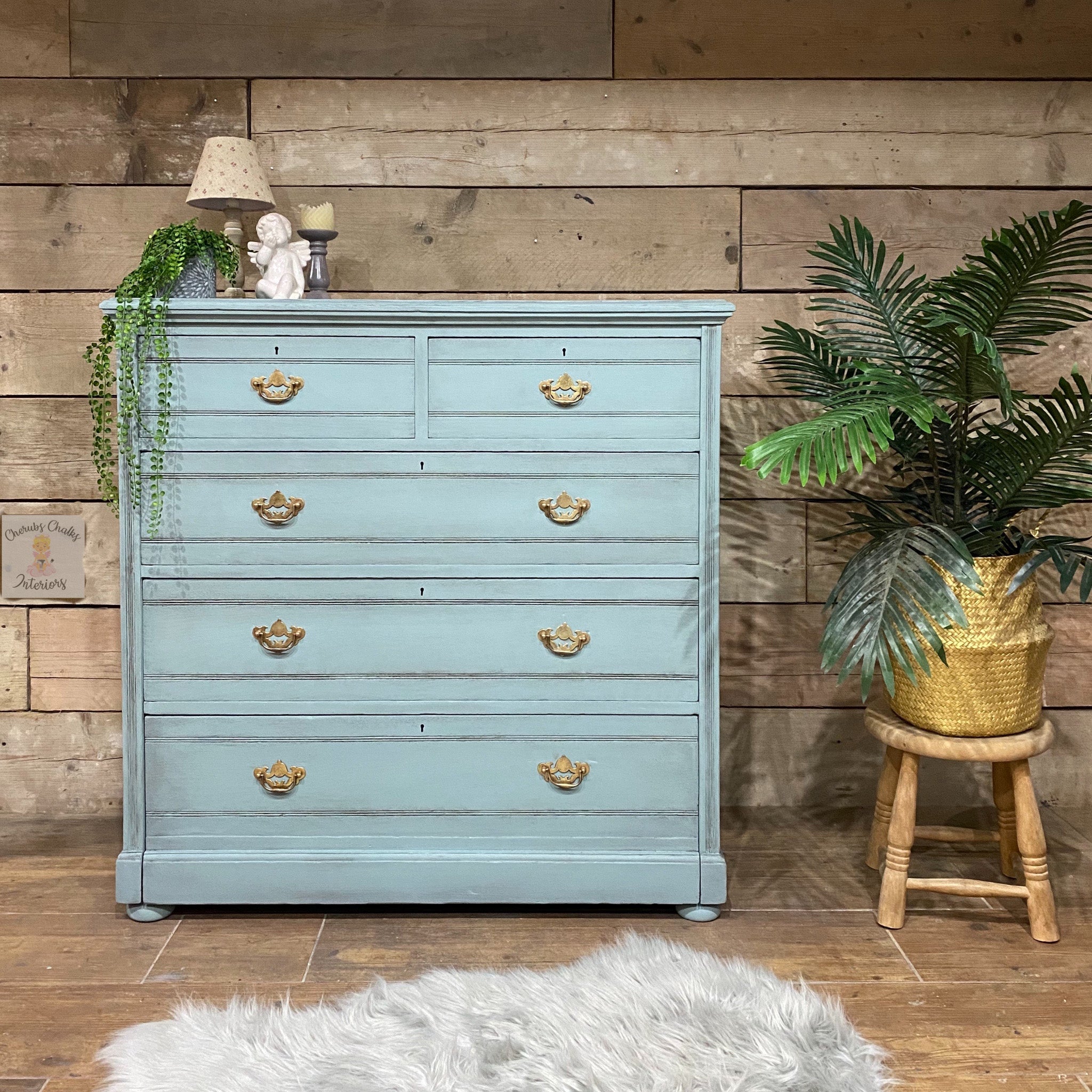 A vintage 5-drawer chest dresser refurbished by Cherubs Chalks Interiors is painted in Dixie Belle's Vintage Duck Egg chalk mineral paint.