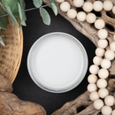 An arial view of an open container of Dixie Belle Paint Company’s Driftwood Chalk Mineral Paint is surrounded by a wood bead garland, driftwood, and a wicker basket.