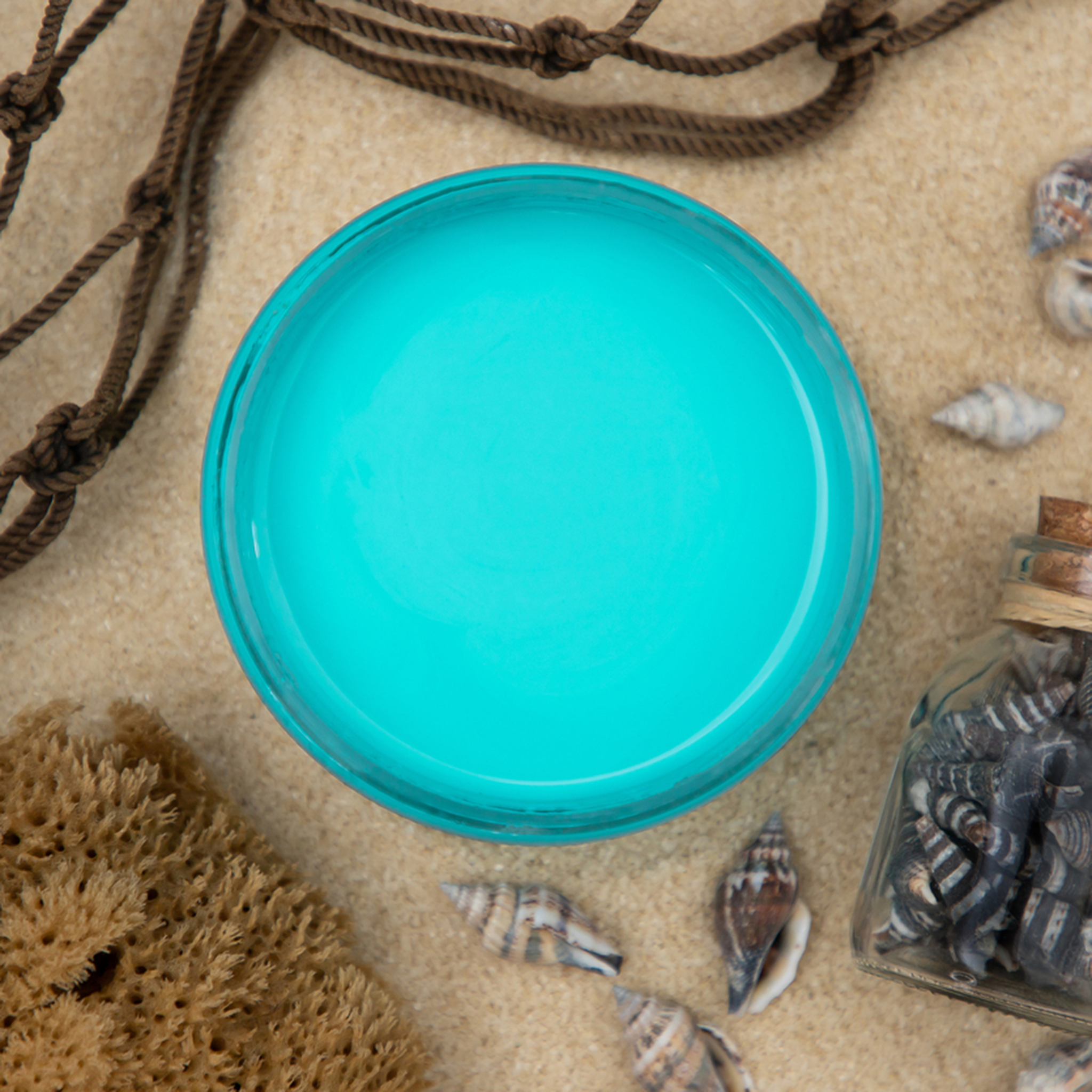 An arial view of an open container of Dixie Belle Paint Company’s Pure Ocean Chalk Mineral Paint is surrounded by shells and ropes.