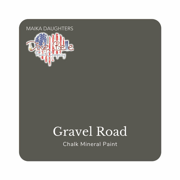 A square swatch card of Dixie Belle Paint Company’s Gravel Road Chalk Mineral Paint is against a white background. This color is a rich gray.