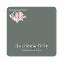A square swatch card of Dixie Belle Paint Company’s Hurricane Gray Chalk Mineral Paint is against a white background. This color is a dark slate gray.