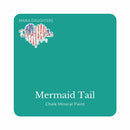 A square swatch card of Dixie Belle Paint Company’s Mermaid Tail Chalk Mineral Paint is against a white background. This color is a turquoise blue.