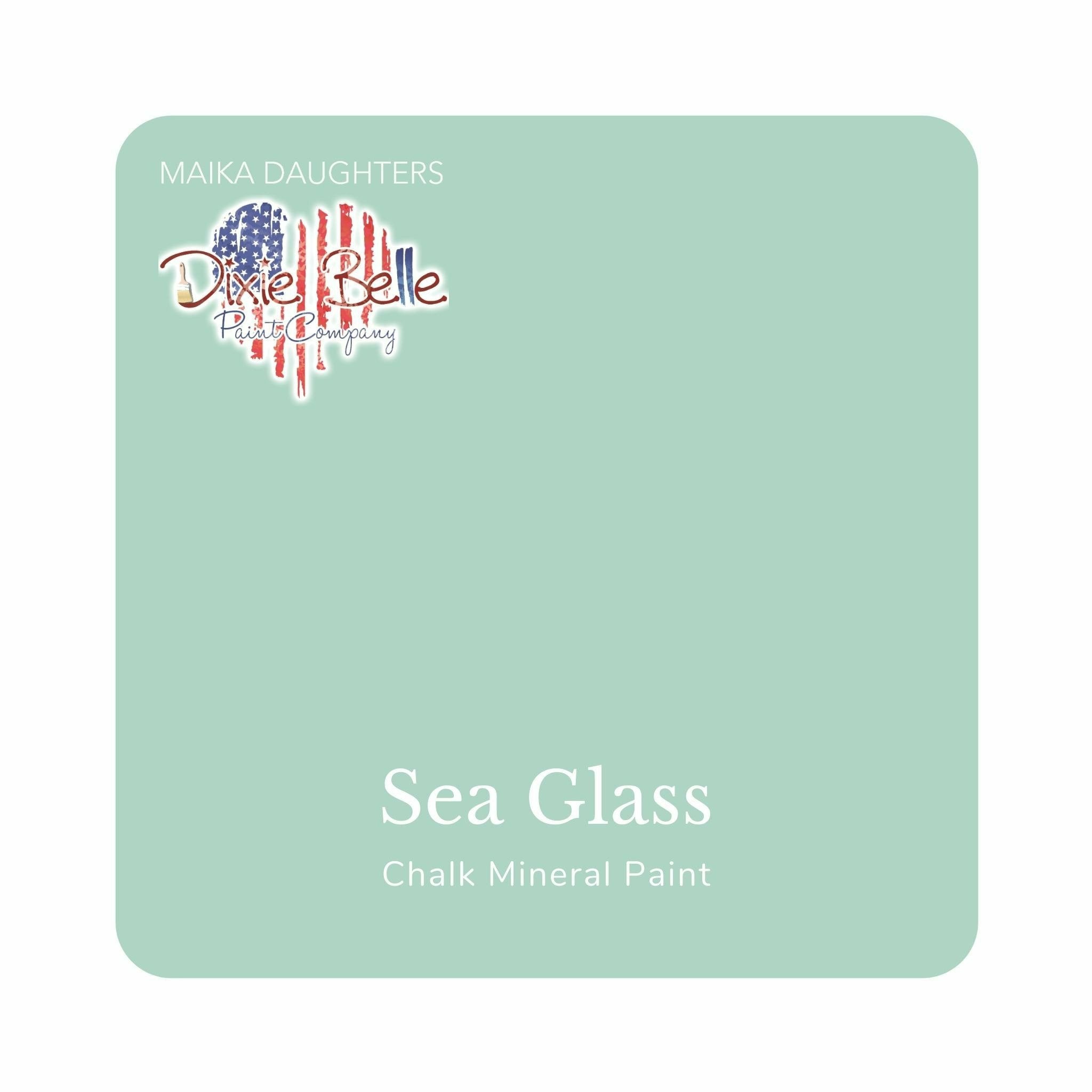 A square swatch card of Dixie Belle Paint Company’s Sea Glass Chalk Mineral Paint is against a white background. This color is a blue light gray.