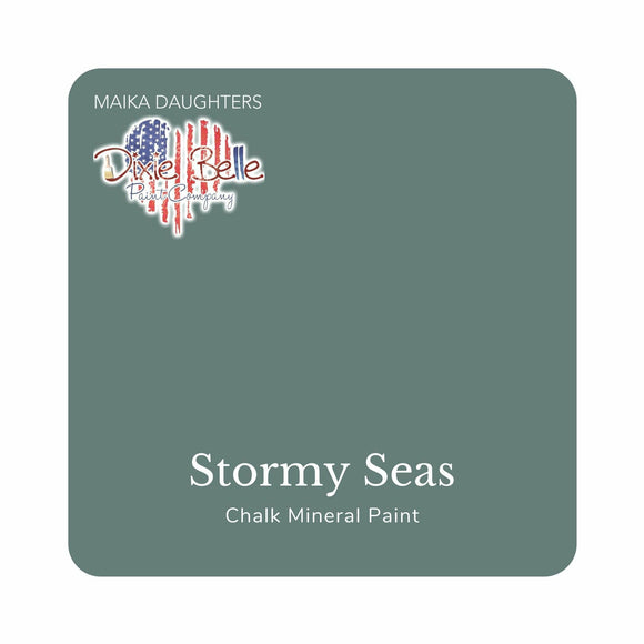 A square swatch card of Dixie Belle Paint Company’s Stormy Seas Chalk Mineral Paint is against a white background. This color is a light slate gray with blue undertones.