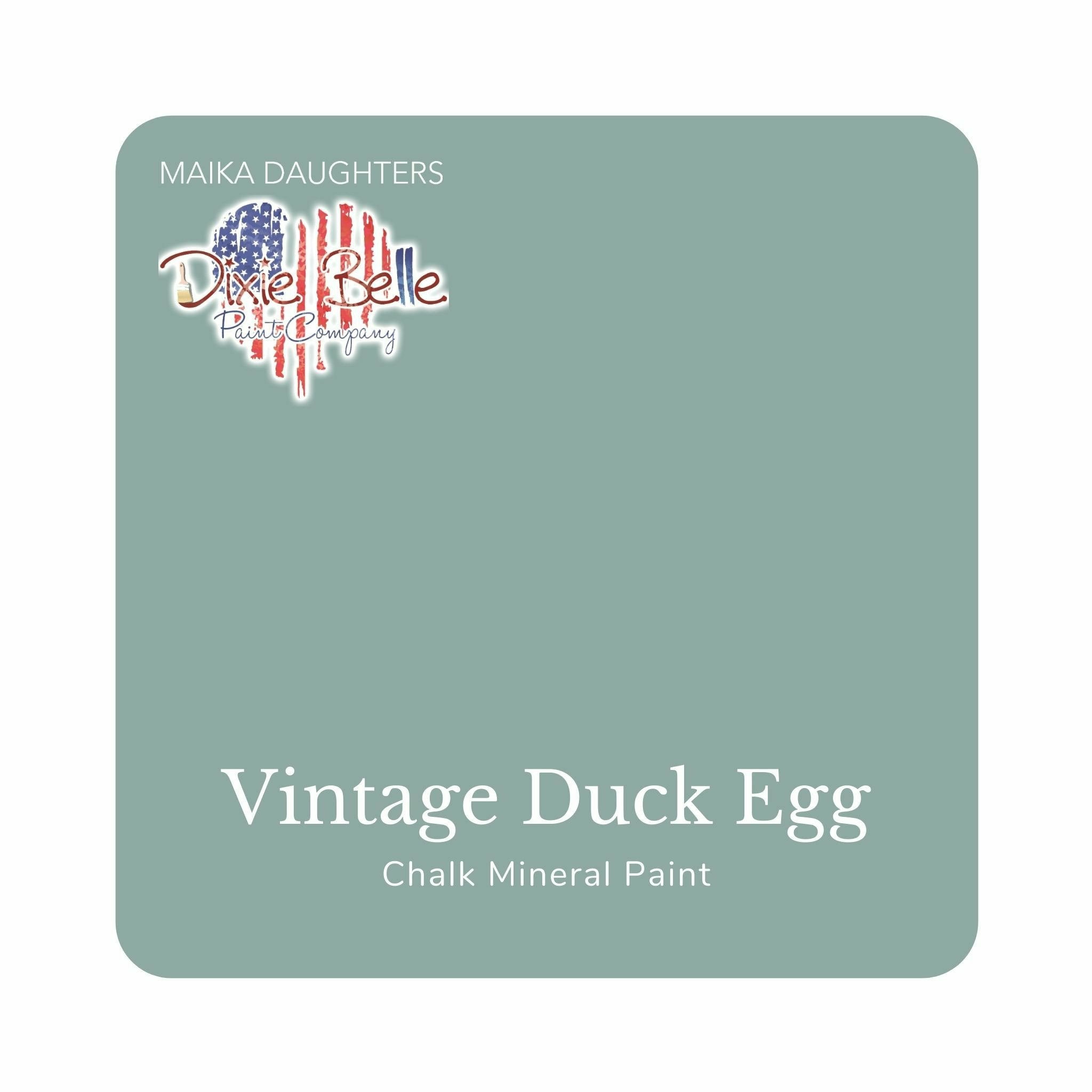 A square swatch card of Dixie Belle Paint Company’s Vintage Duck Egg Chalk Mineral Paint is against a white background. This color is a soft light blue with hints of gray and green.