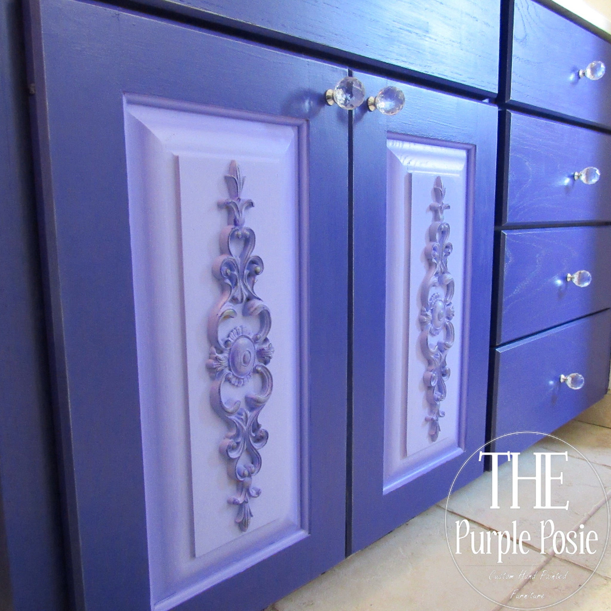 A close-up view of bottom cabinet doors and drawers feature Dixie Belle's Amethyst Chalk Mineral Paint.