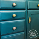 A close-up of a dresser refurbished by Mustard Tree Market is painted with Dixie Belle's Antebellum Blue chalk mineral paint.