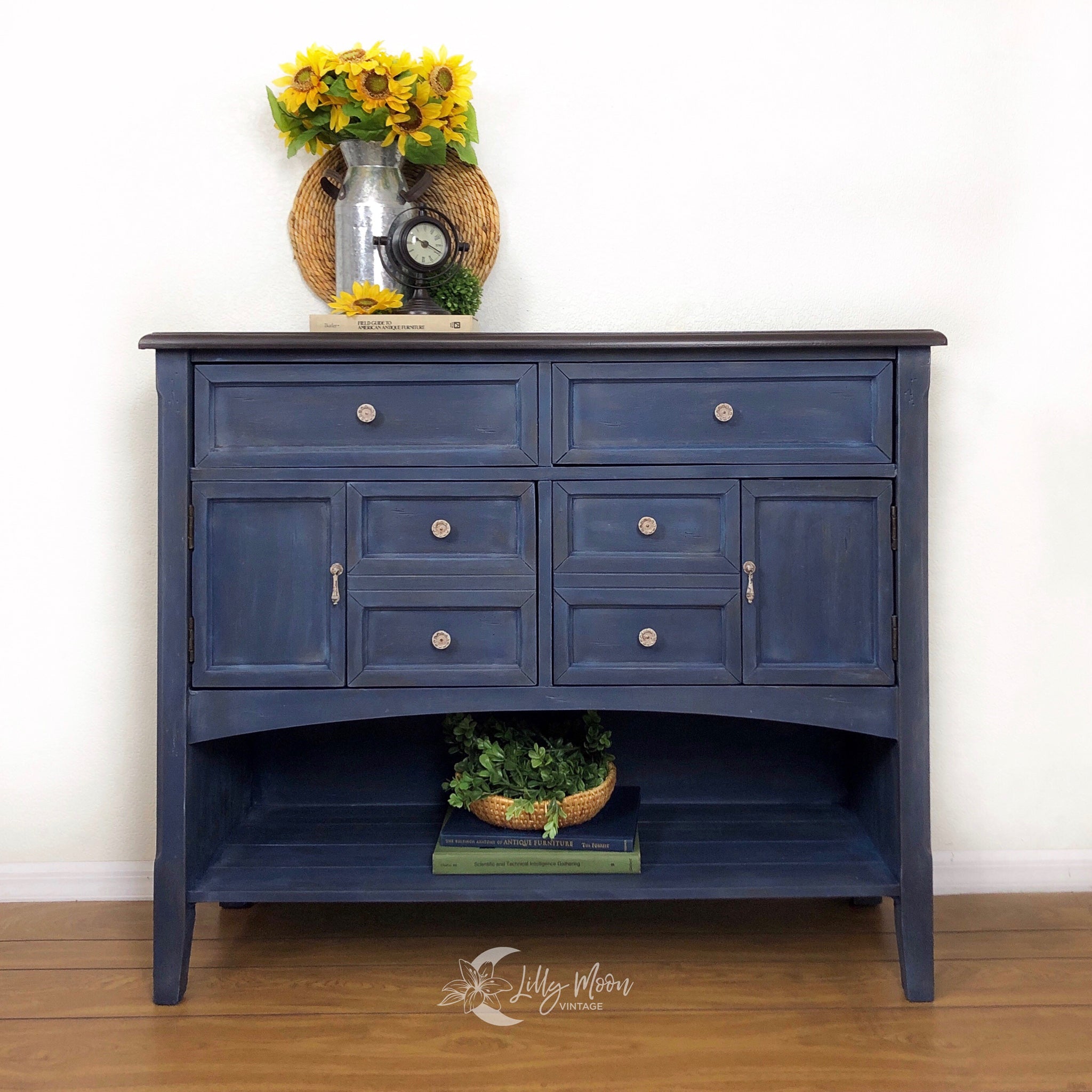 A vintage console table with storage refurbised by Lilly Moon Vintage features Dixie Belle's Bunker Hill Blue chalk mineral paint.