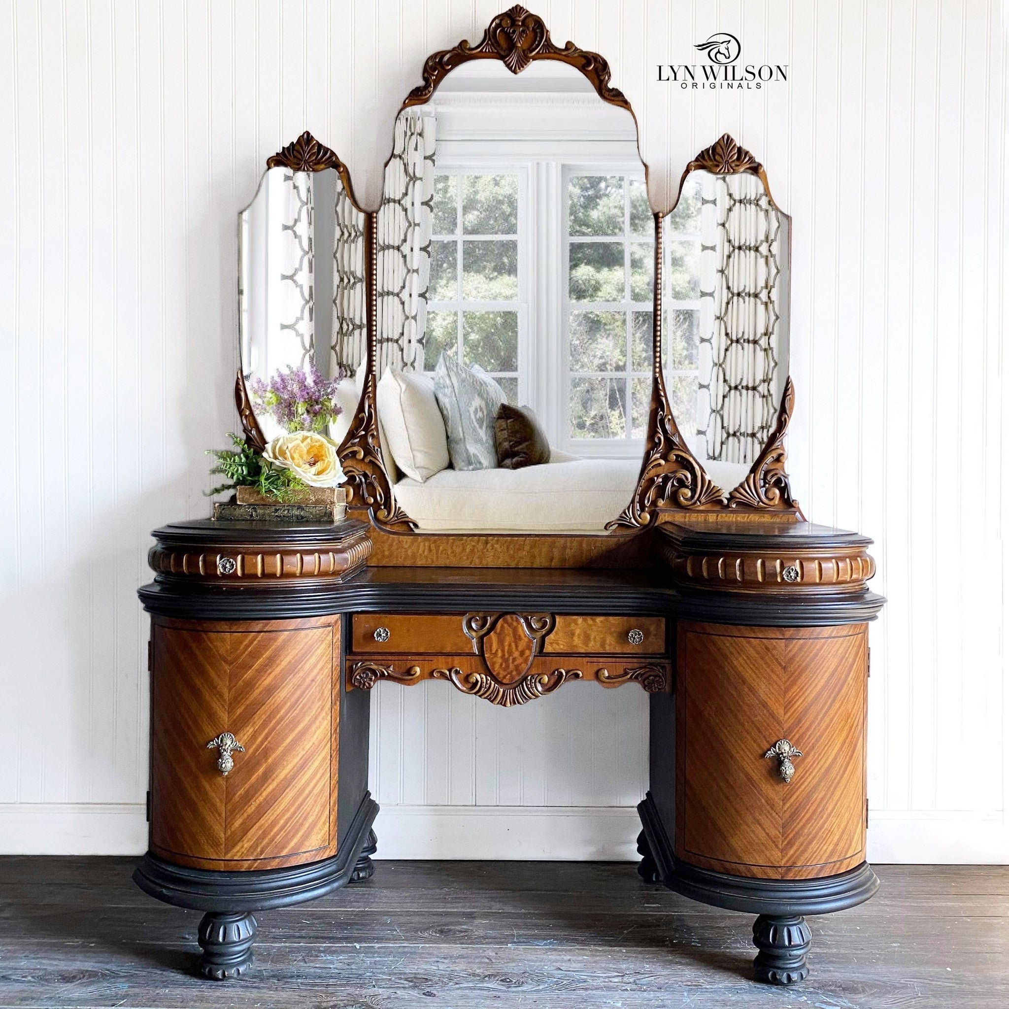 A vintage vanity with a tri-fold mirror refurbished by Lyn Wilson Originals has natural golden wood with Dixie Belle's Coffee Bean chalk mineral paint.
