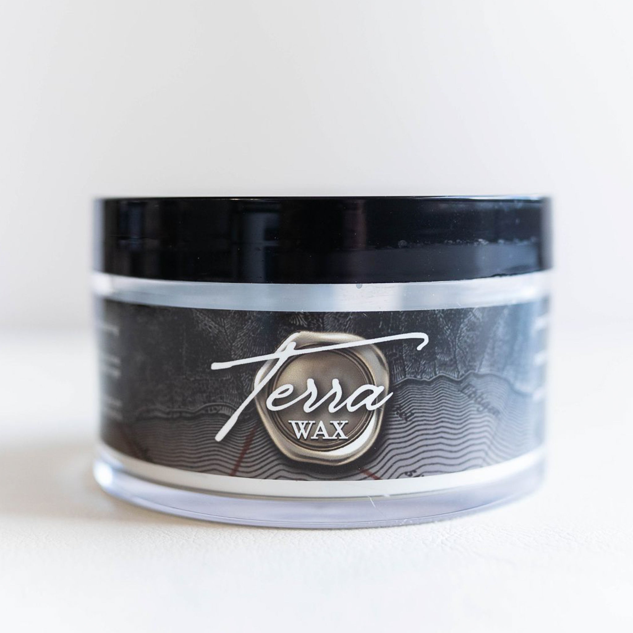 A container of Dixie Belle's Terra Wax is against a white background. This wax is perfect for providing a rock-hard finish  that will preserve your details instead of making them blurry or flattened.