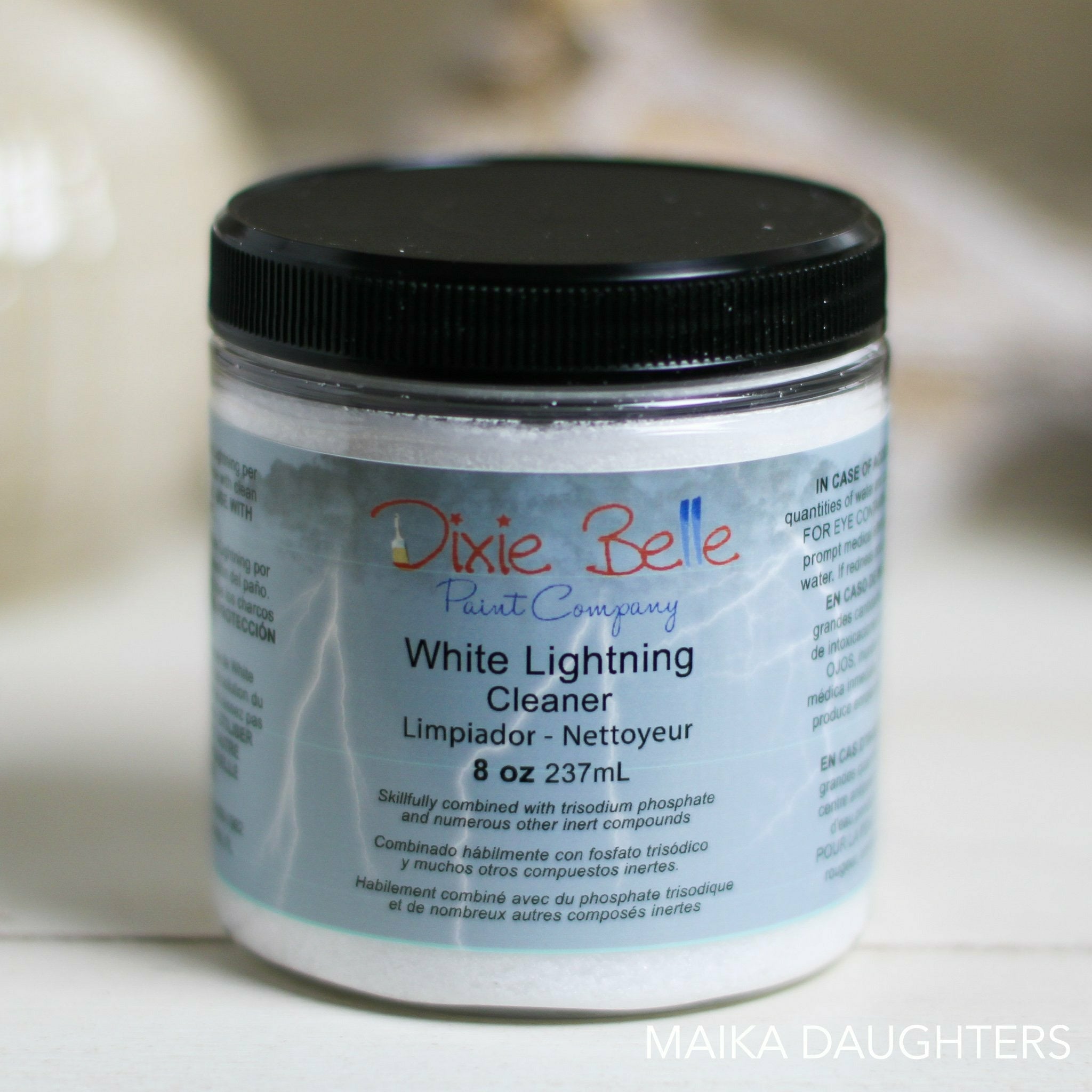 An 8oz container of Dixie Belle's White Lightning Cleaner is against a light beige background. This furniture cleaner will de-grease and remove all debris from your furniture, kitchen cabinets or whatever you want to paint.