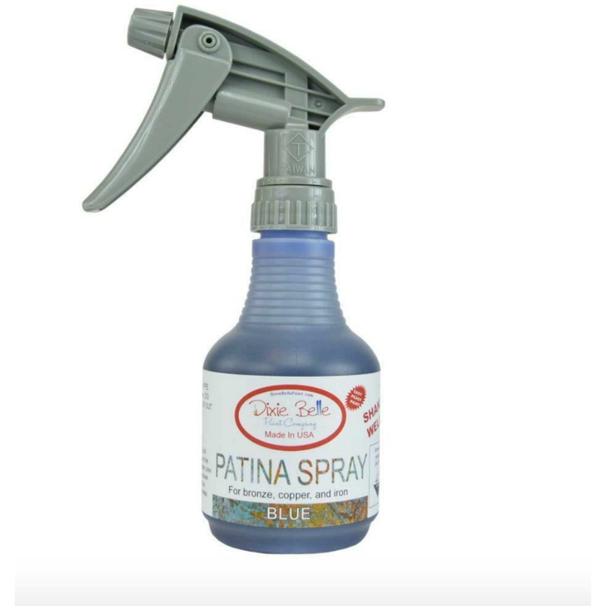 An 8oz spray bottle of Dixie Belle Paint Company's Patina Spray in Blue is against a white background.Belle patina spray blue