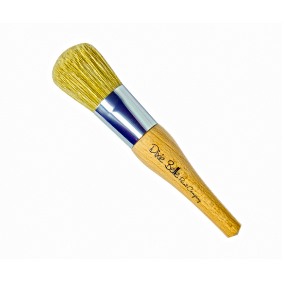 Dixie Belle's The Belle Paint Brush is against a white background.  Its distinctive belle design offers a comfortable grip and tapered edges, making it the ideal partner for achieving stunning, polished finishes.