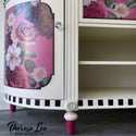A close-up of a vintage dresser refurbished by Theresa Lee NTS Design Company is painted a light cream color with pink inlays. The inlays feature the Floral Romance transfer.