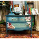 A blue vanity with the Somewhere in France transfer on top. A Cece Restyled furniture plus art logo on the top left.