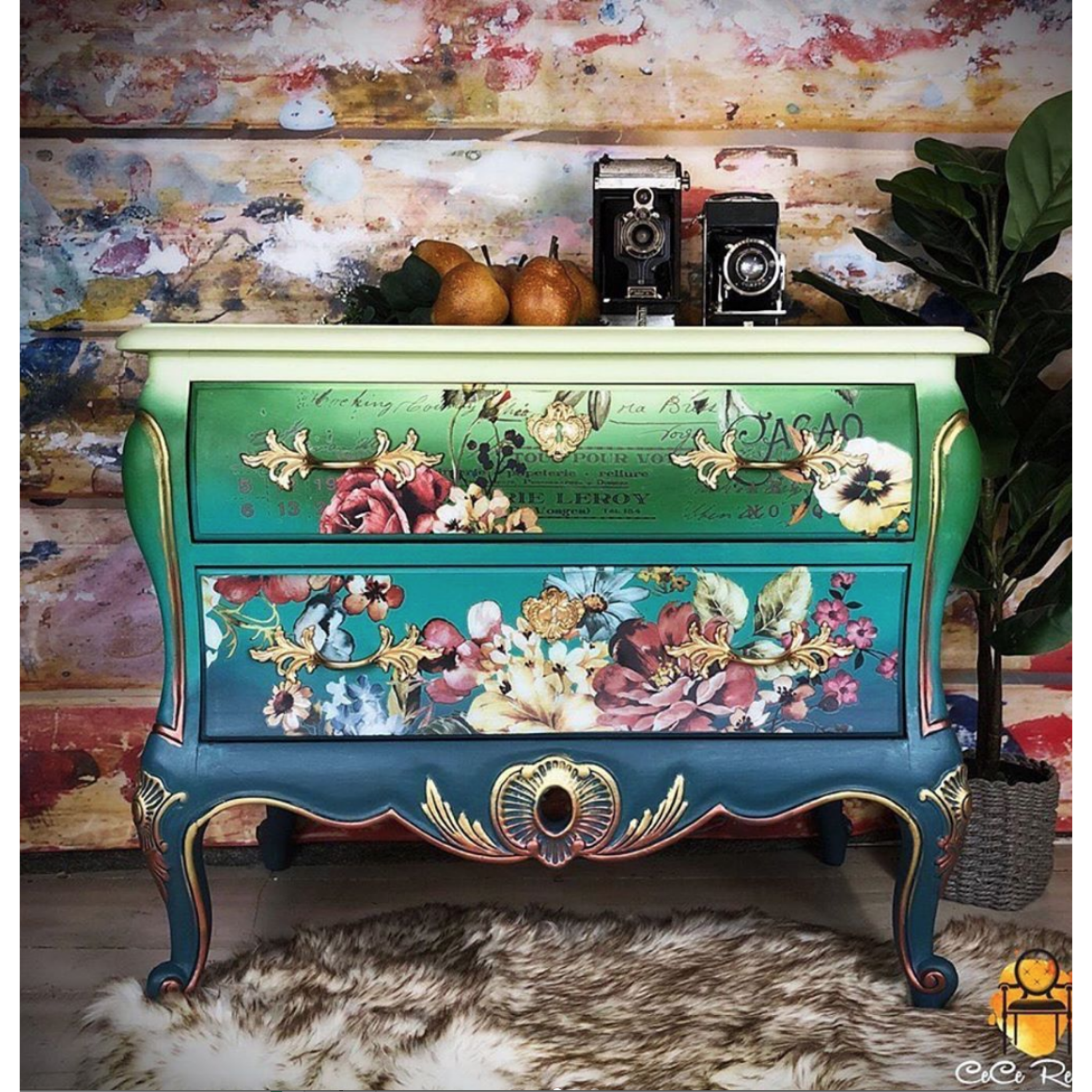 A vintage dresser refurbished by CeCe ReStyled is painted an ombre blend of green down to blue with gold accents and features ReDesign with Prima's Ruby Rose transfer on the drawers.