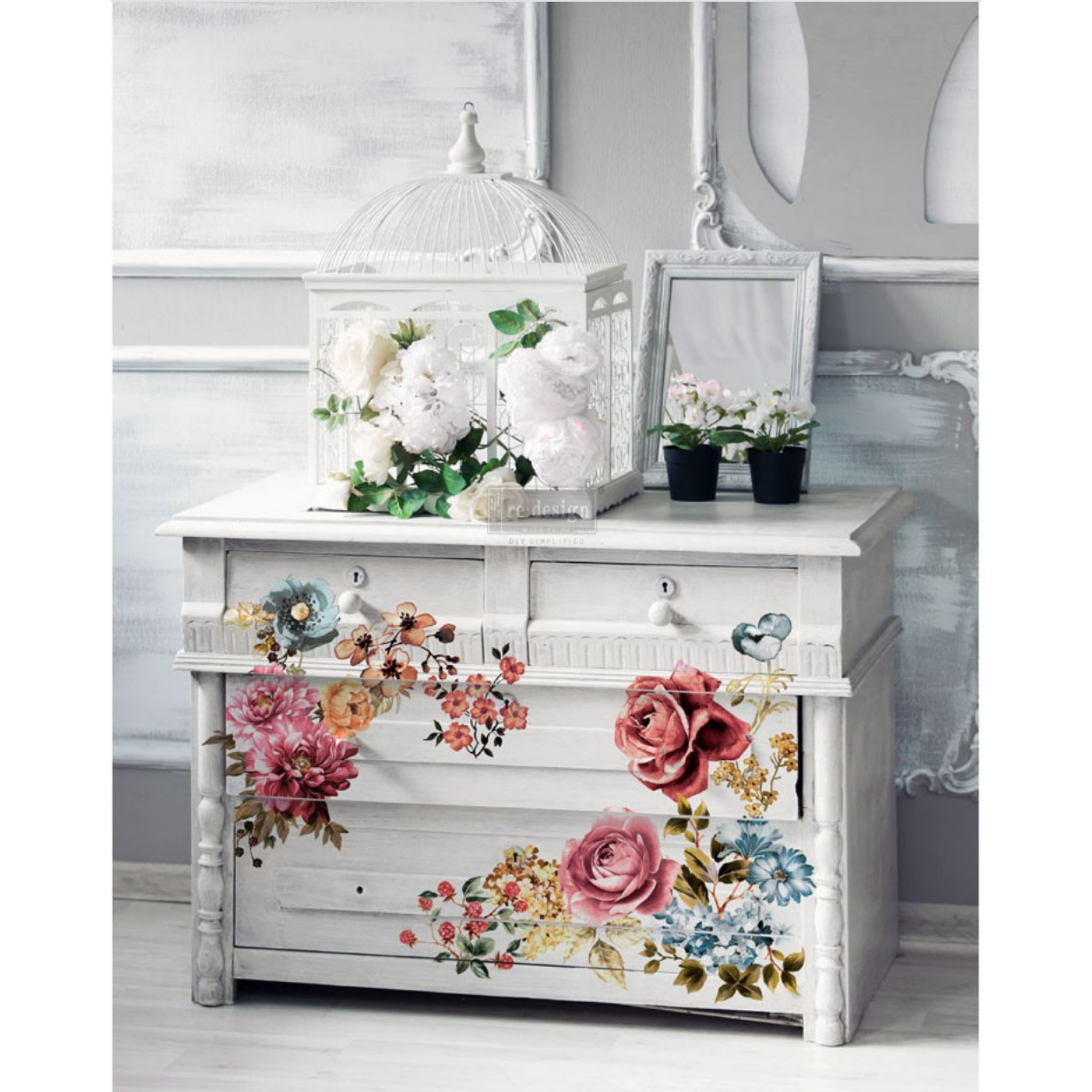 A small white dresser features ReDesign with Prima's Ruby Rose transfer on it.