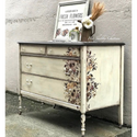 A off white dresser with the Sunflower Farms transfer on top. A white Her Shabby Chateau logo on the top right.