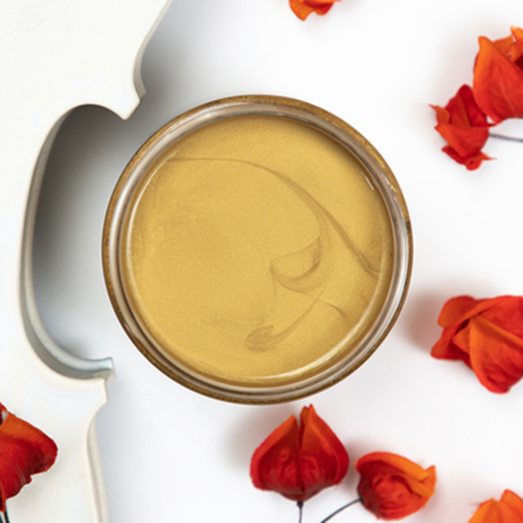 A open Gold Digger Dixie Belle Moonshine Metallic Chalk Paint container.