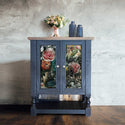 A vintage 2-door side table is painted blue with a natural wood top and features the Andressa tissue paper on its doors.