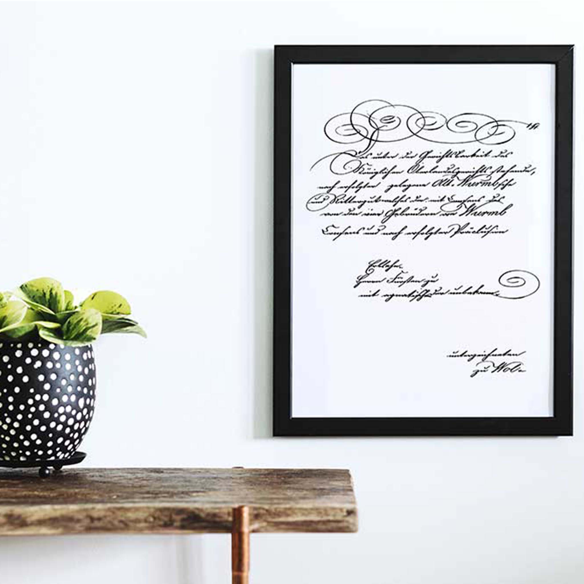 A black photo frame features ReDesign with Prima's Secre Letter small transfer against a white background.