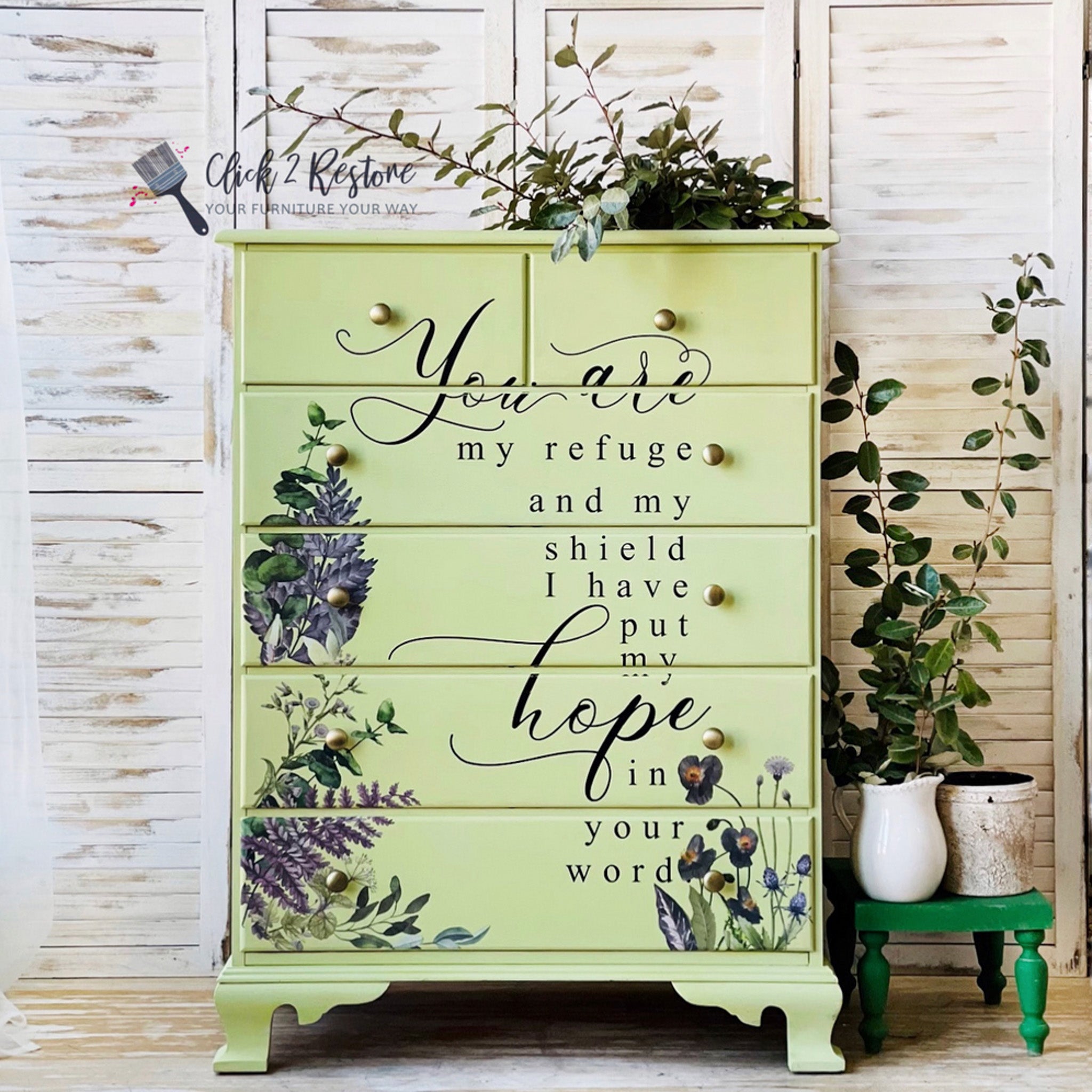 A vintage chest dresser refurbished by Click 2 Restore is painted pale yellow and features pieces of ReDesign with Prima's Vigorous Violet transfer on its drawers.