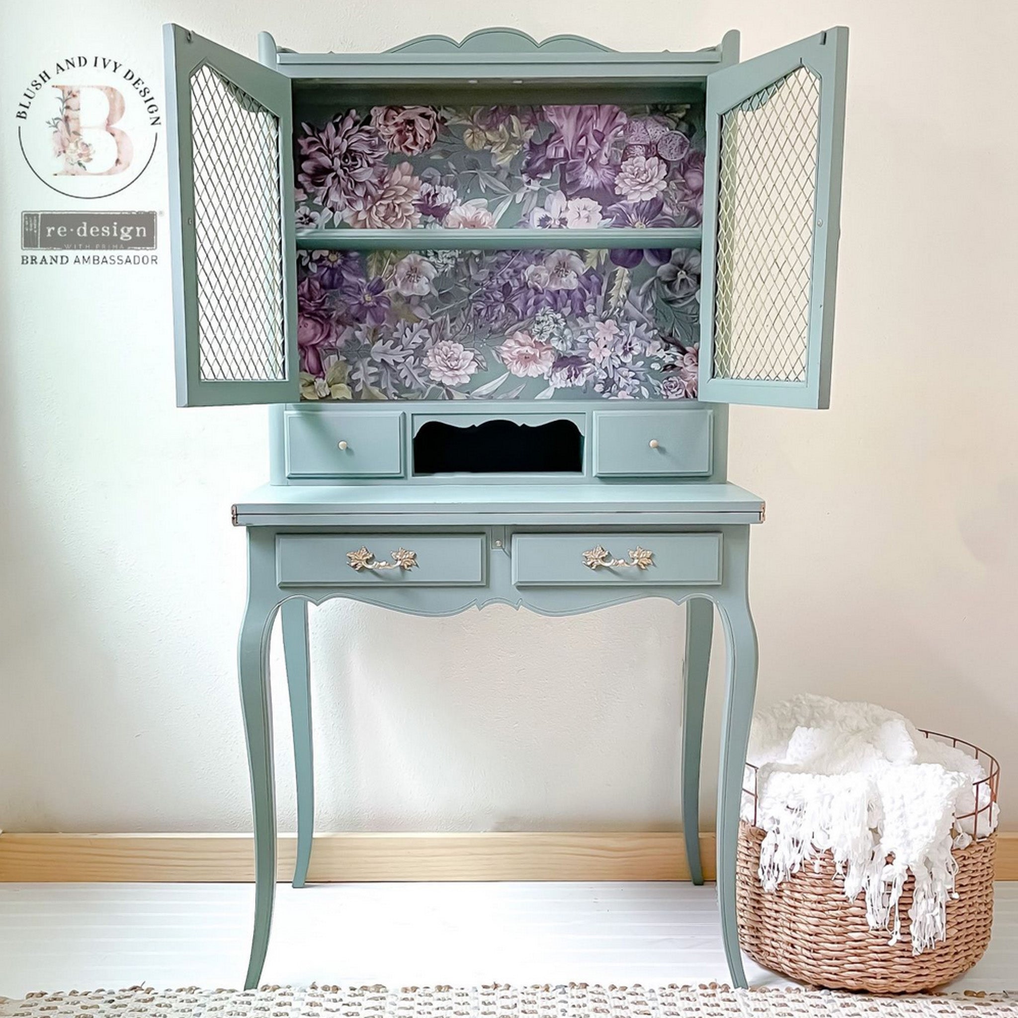 A vintage desk with a small hutch top refurbished by Blush and Ivy Design is painted pale blue and features ReDesign with Prima's Vigorous Violet transfer against the hutch backboard.