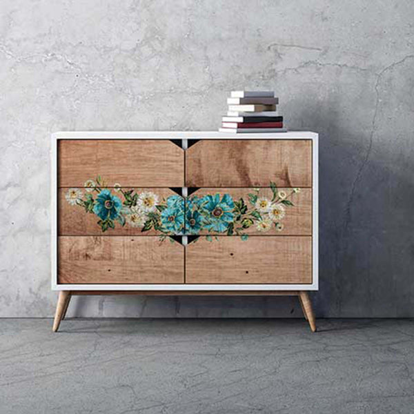 A 6-drawer dresser is painted white and features the Gilded Floral small transfer on its natural wood stained drawers.