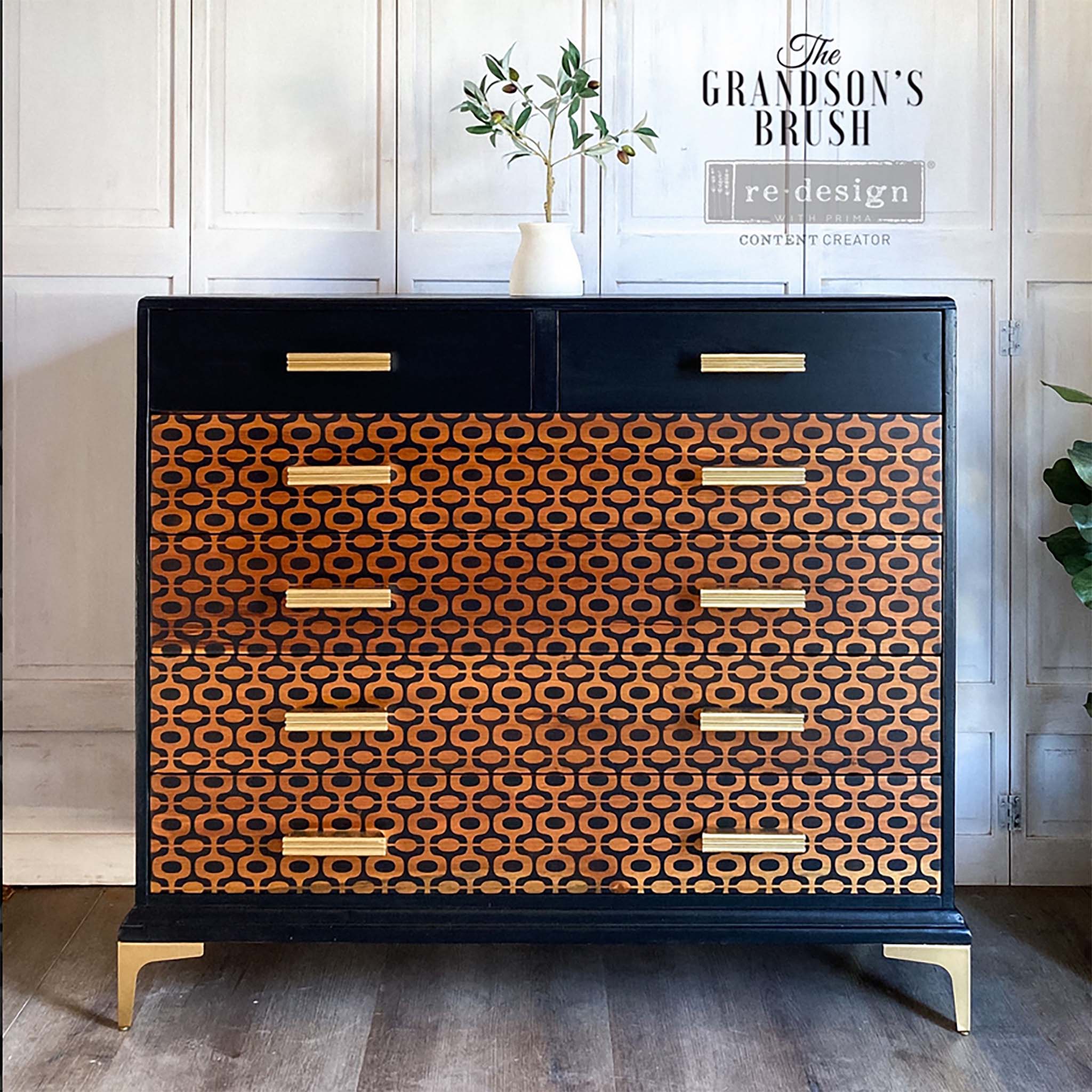 A vintage dresser refurbished by The Grandson's Brush is painted black with natural wood stain on all but the top 2 drawers and features ReDesign with Prima's Midcentury Vibes stencil in black on the natural stained drawers.