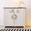 A small side table cabinet that's painted light grey that features the A Gilded Moment small transfer on its doors.