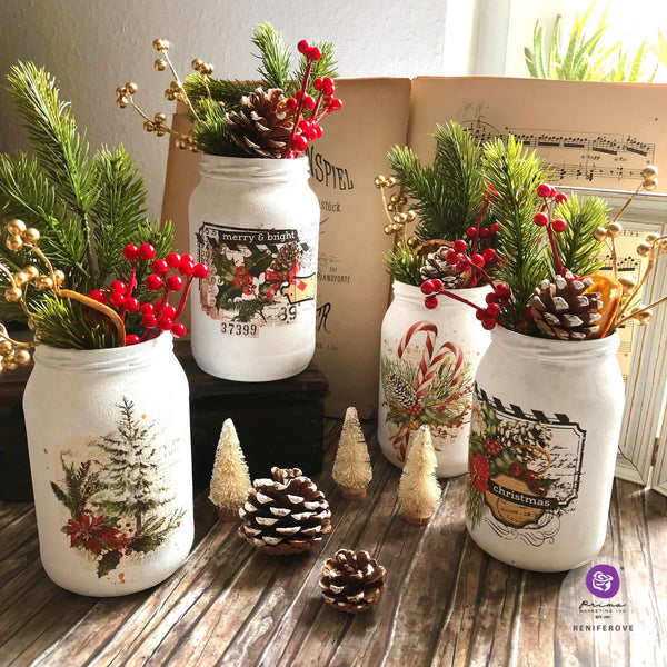 Four white painted mason jars feature the Classic Christmas small transfer on them.