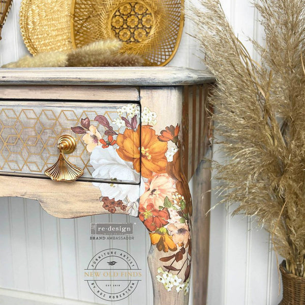 Close-up of a vintage desk refurbished by New Old Finds is stained a nautral wood color with bronze accents and features the Classic Peach Flowers small transfer on it.