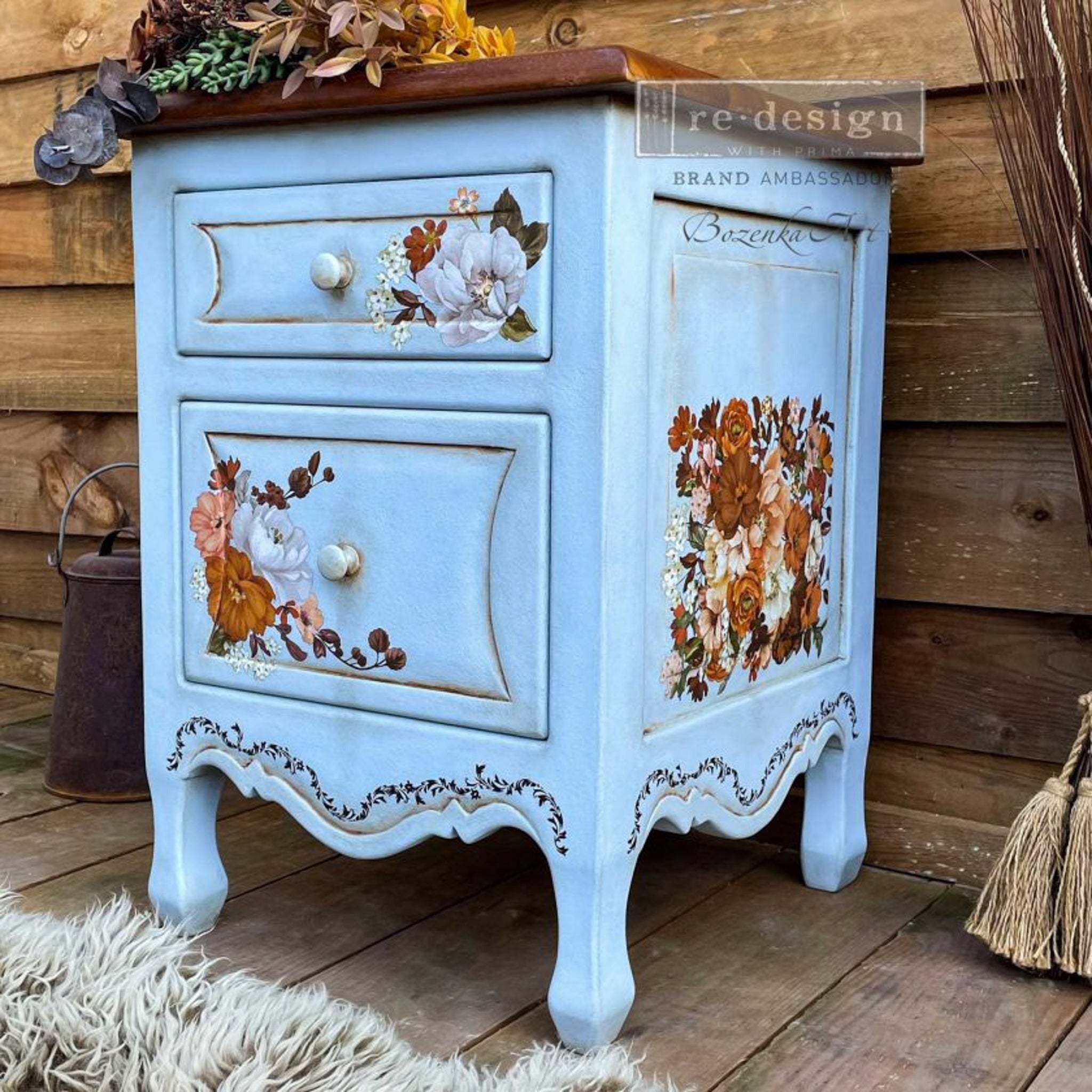 A small 2-drawer nightstand refurbished by Bozenka Art is painted a light blue and features the Classic Peach Flowers small transfer on its drawers.