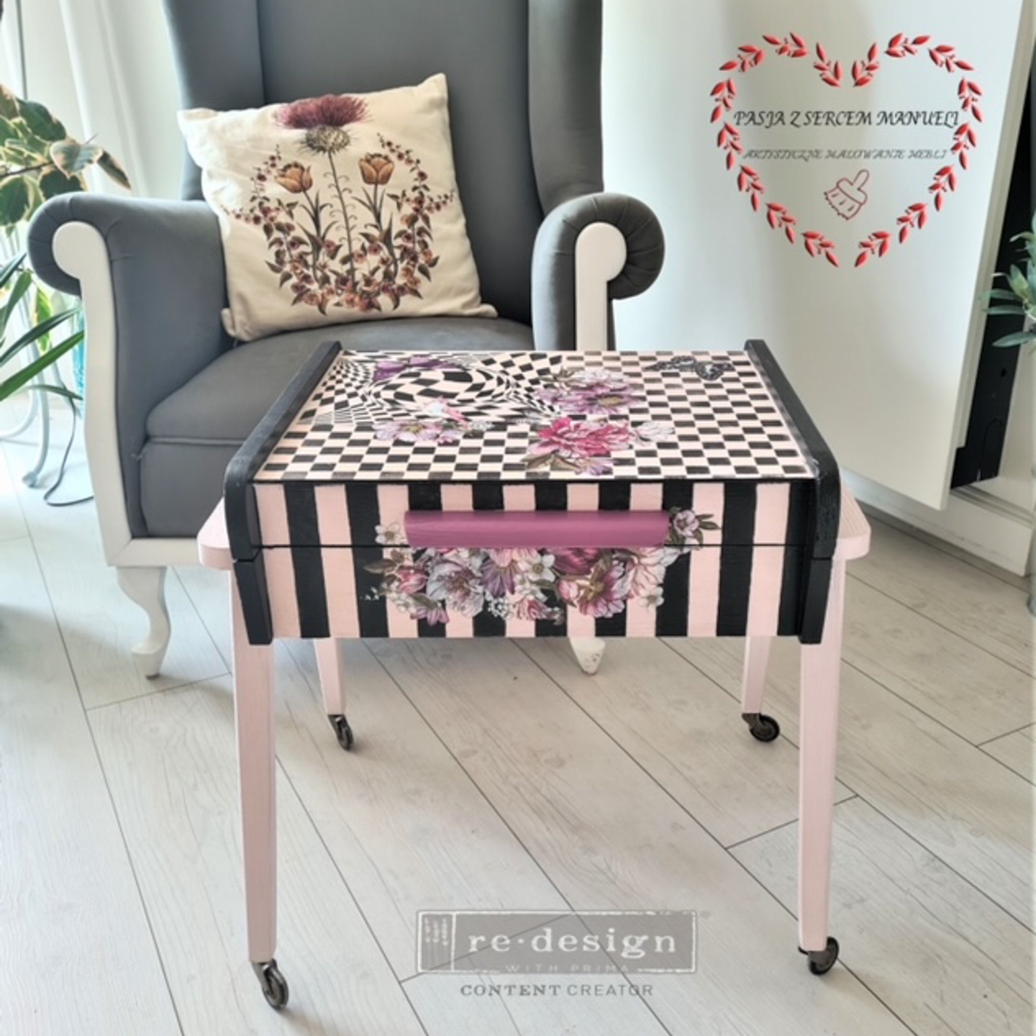 A vintage side table is painted pale pink with black stripes and checkers and features the Dreamy Florals small transfer on it.