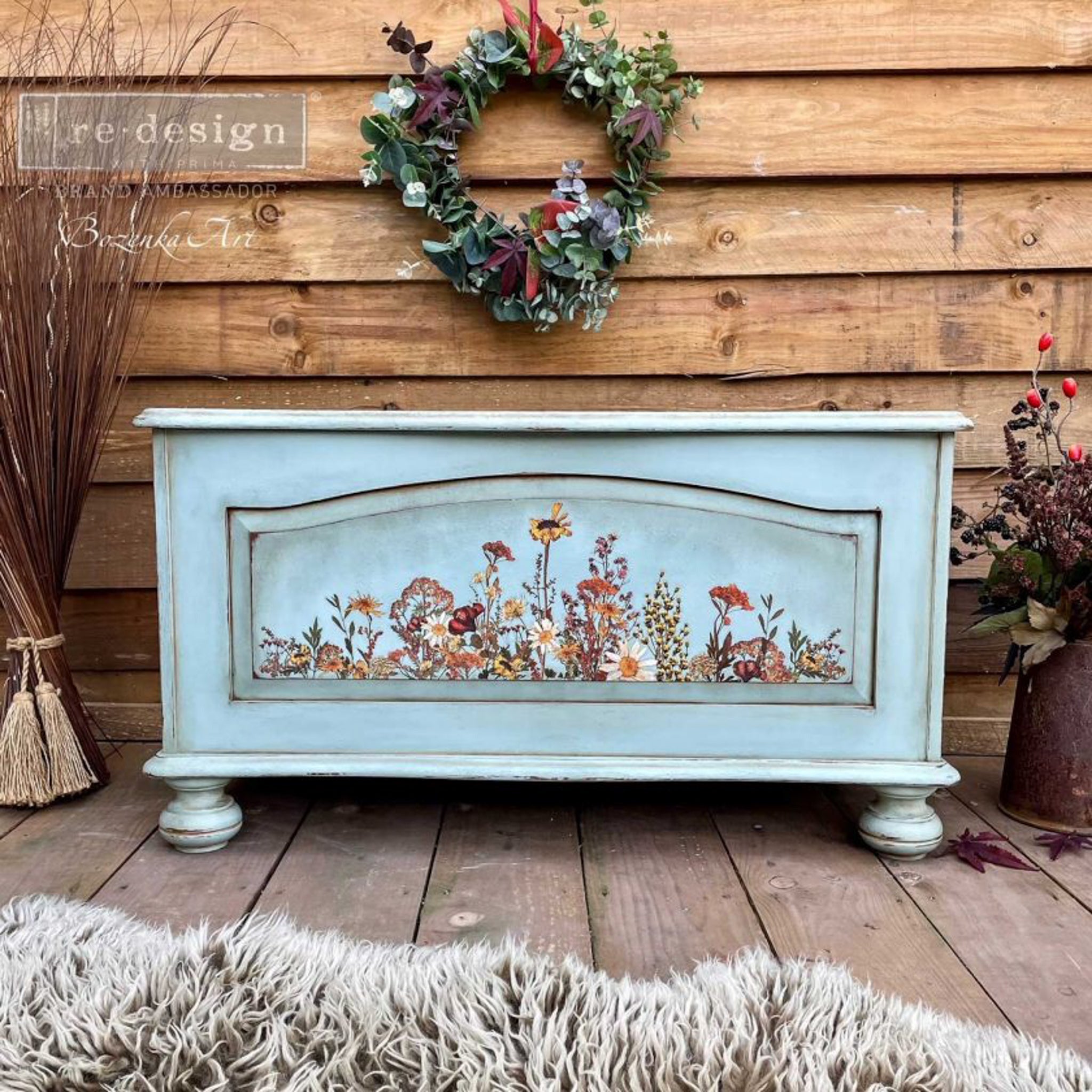  A vintage storage chest refurbished by Bozenka Art is painted pale blue and features the Dried Widflowers small transfer on it.