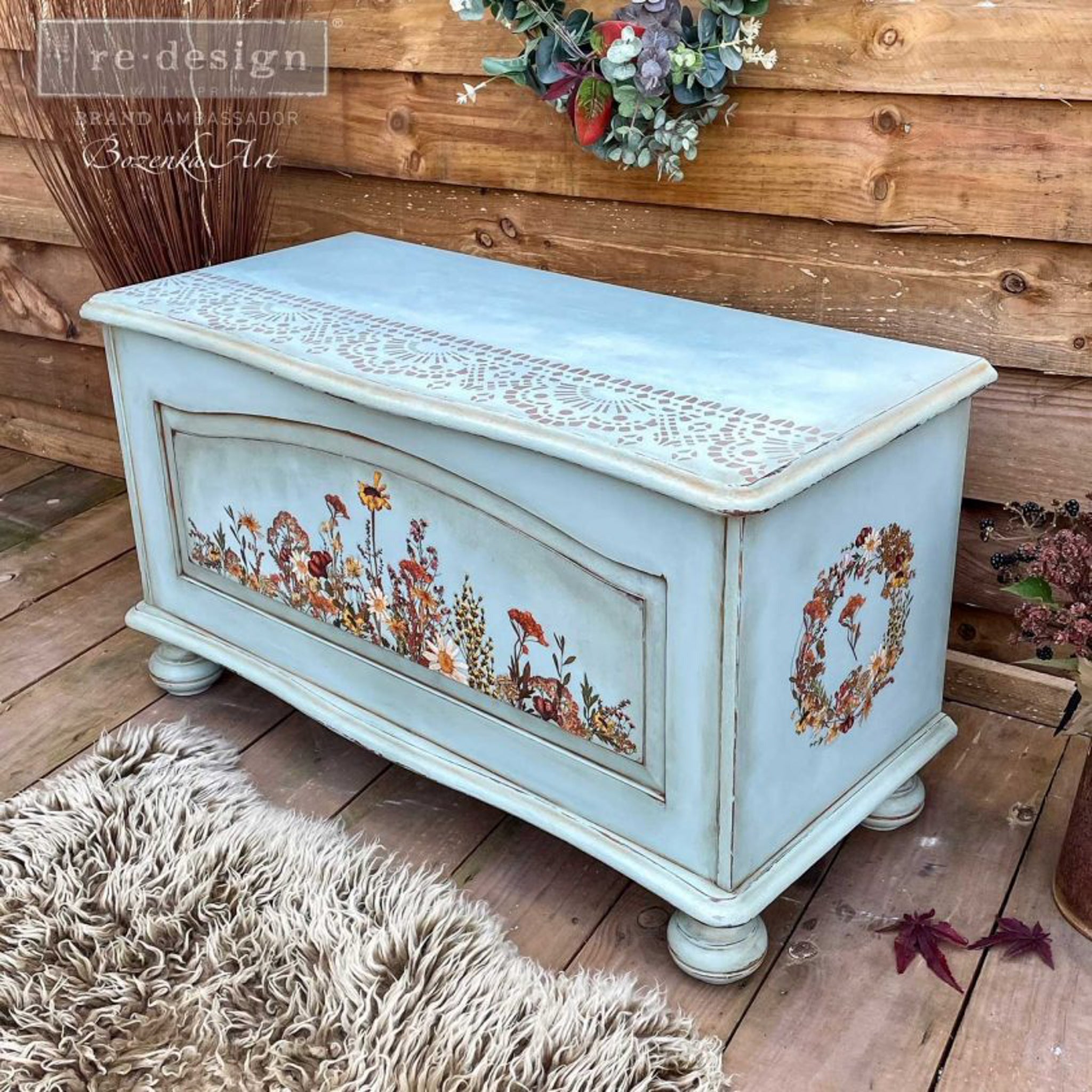 A vintage storage chest refurbished by Bozenka Art, a ReDesign with Prima Brand Amabassador, is painte pale blue and features the Dried Widflowers small transfer on it.