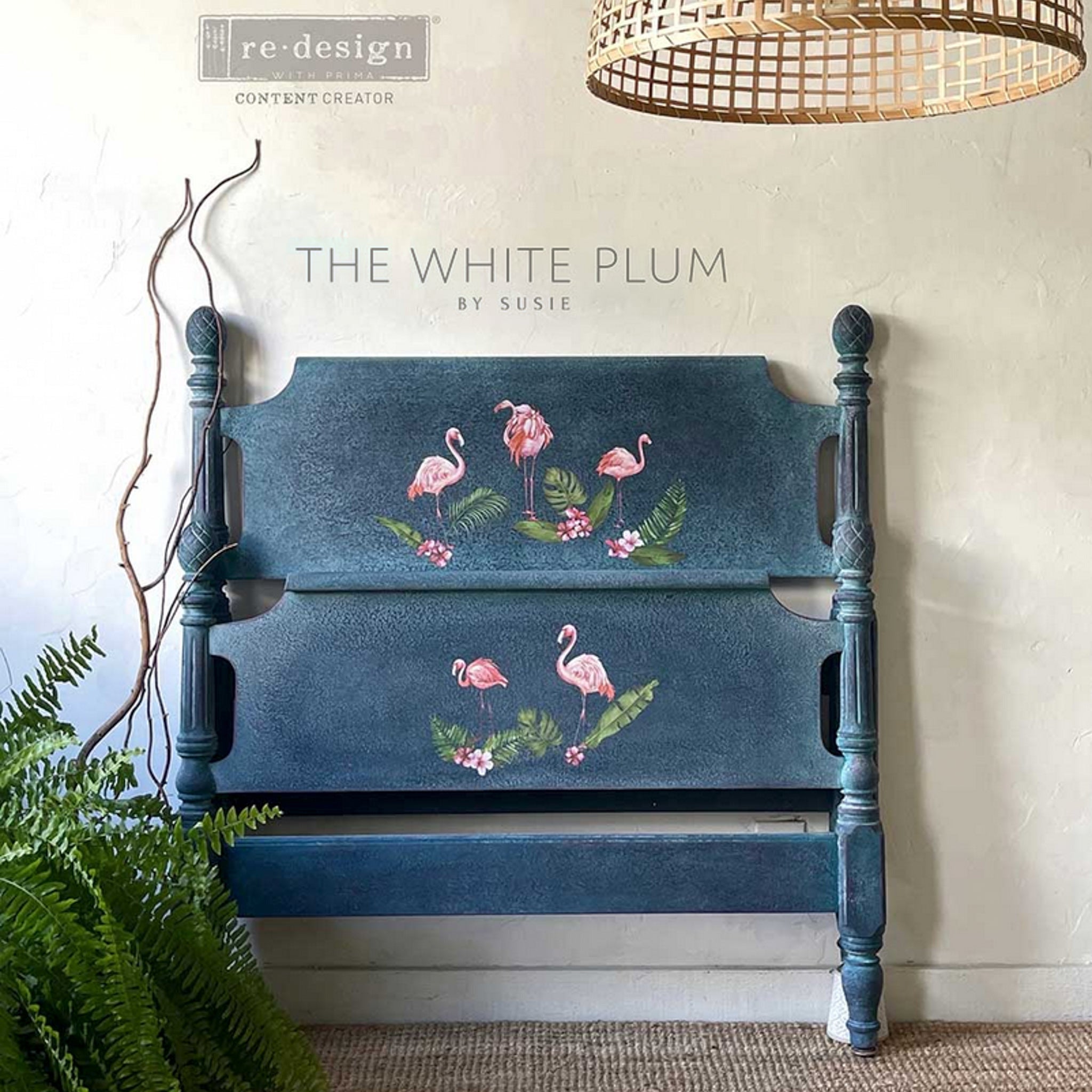 A twin headboard and footboard refurbished by The White Plum by Susie are painted blue and feature the Falimgo Pink small transfer on them.
