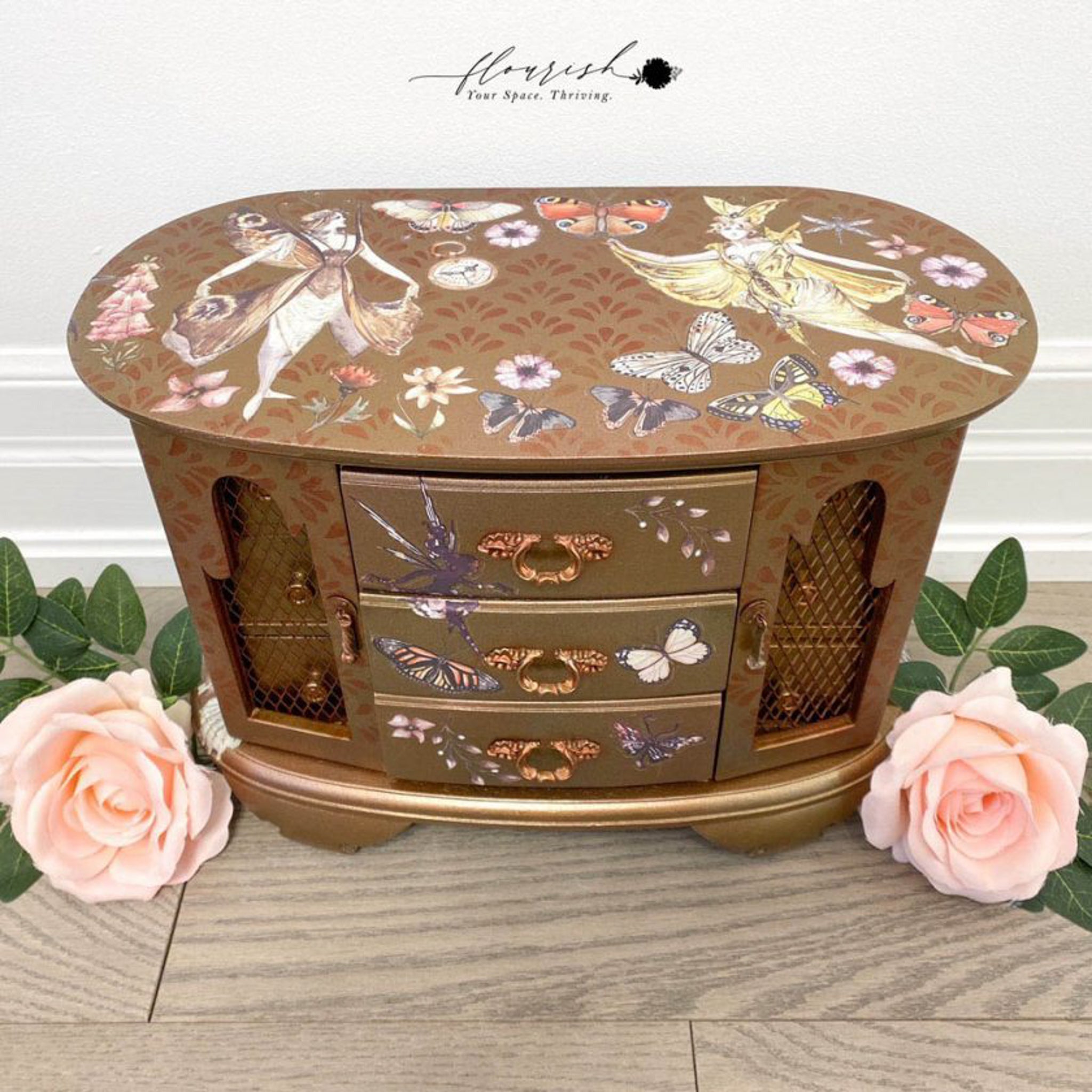 A vintage table top jewelry box refurbished by Flourish You Space Thriving is painted metallic brown and features the Forest Fairies small transfer on it.