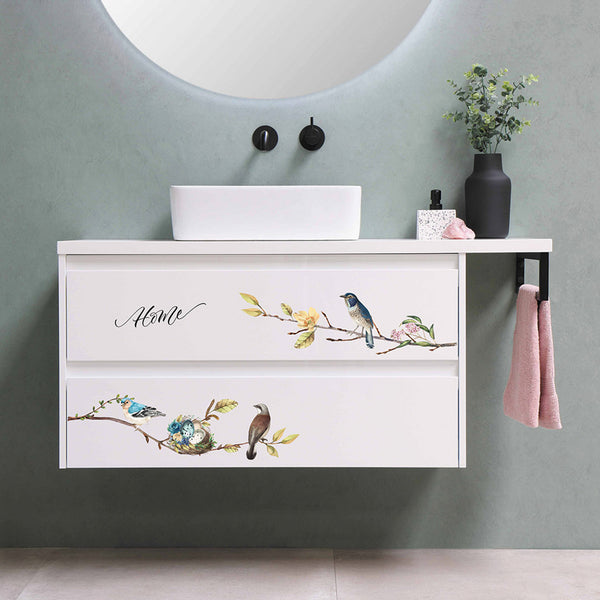 A floating 2-drawer nightstand is painted white and features the Garden Marvels small transfer on it.