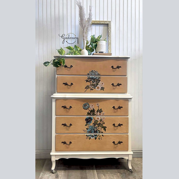 A 5-drawer dresser is painted white and peach and features the Gilded Floral small transfer on its drawers.