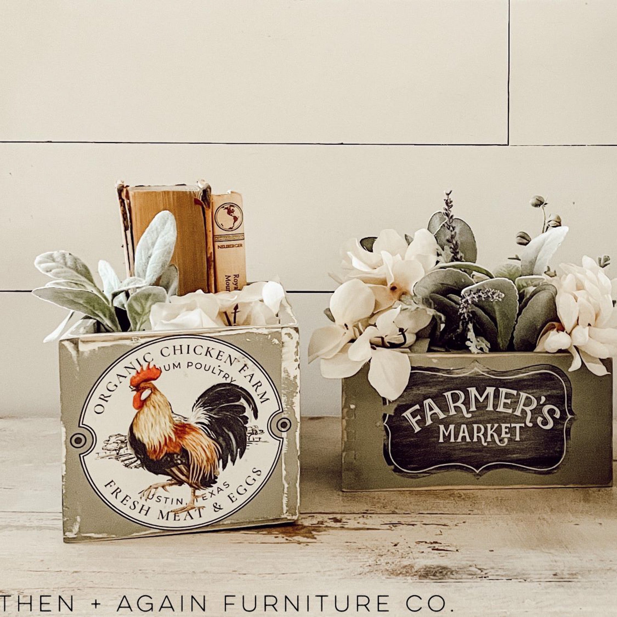 Two wood boxes made into flower containers refurbished by Then + Again Furniture Co. are painted soft greens and feature ReDesign with Prima's Morning Farmhouse small transfer on them.